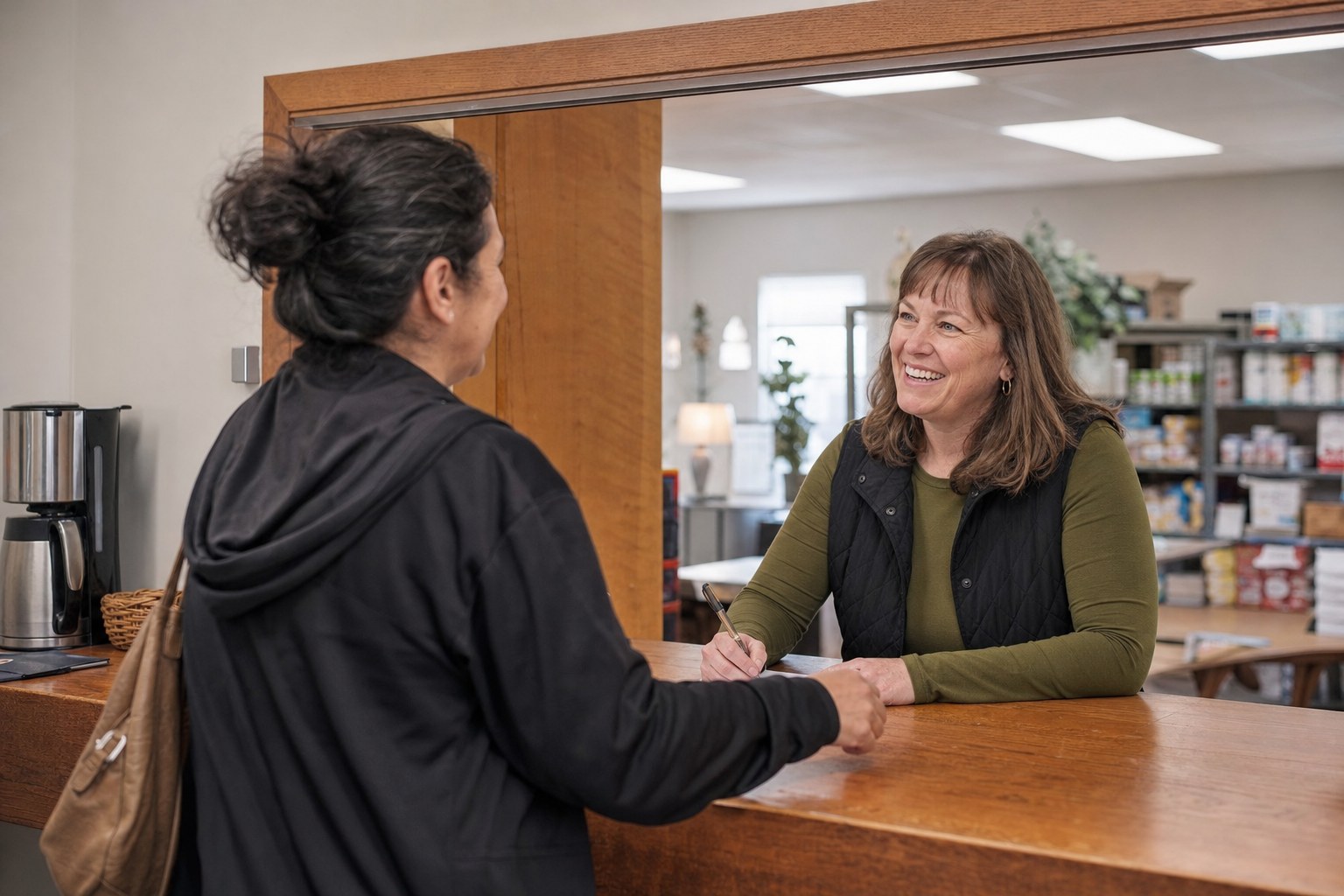 A pantry volunteer welcoming a shopper at check-in